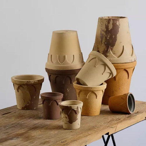 Crown-shaped clay pots in earthy white and brown, assorted sizes; adds rustic charm for indoor plants.