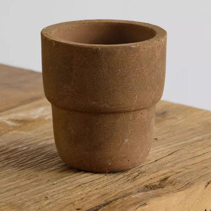 4-inch brown carry cup clay pot with a smooth, minimalist design. Ideal for small plants, adding a warm, earthy tone to indoor decor.