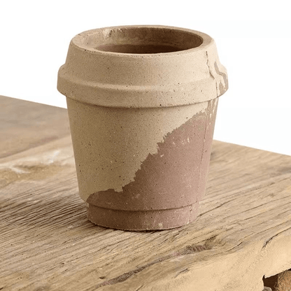 4-inch miniature ceramic planter in a coffee cup design with beige and brown tones, perfect for tiny succulents; rustic finish on wooden tabletop.