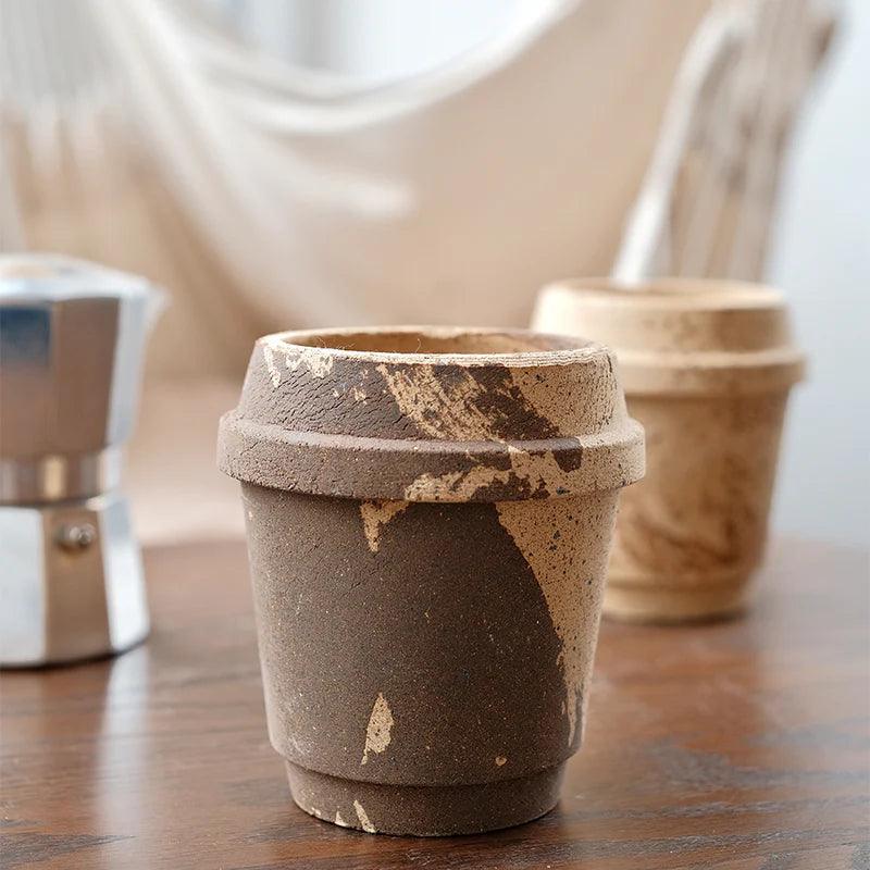 4-inch small clay pot in coffee cup style with marbled brown and beige tones, ideal for tiny succulents; rustic ceramic texture on a wooden table.