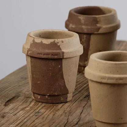 4-inch small stoneware pots in coffee cup style, with natural beige and brown tones, perfect for tiny succulents; rustic finish on a wooden surface.