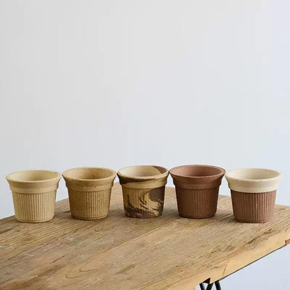 Collection of 5-inch Brûlée cup clay pots in five colors: white, light brown, latte, cocoa, and cream cocoa mix. Ideal for indoor or outdoor greenery.