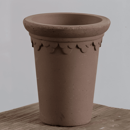 7 inch brown ceramic clover-style pot with decorative edging, perfect for showcasing plants and enhancing indoor spaces.