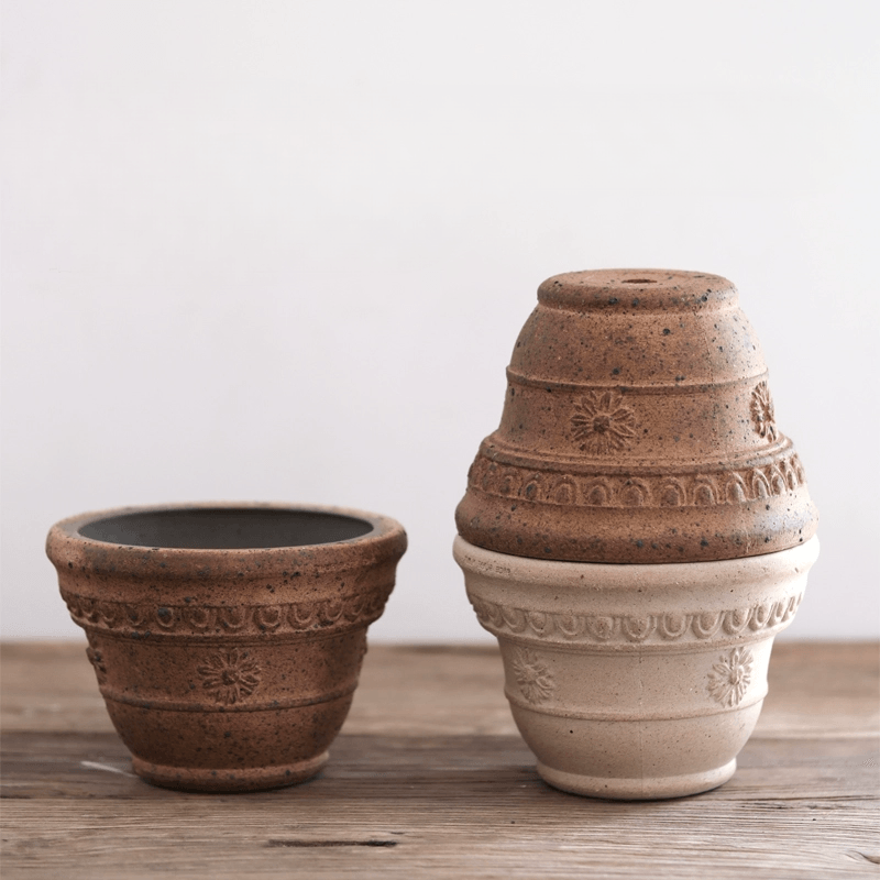 Set of 7-inch Sculpt terracotta planters with decorative patterns. Durable clay pots in earthy tones, ideal for medium-sized plants.