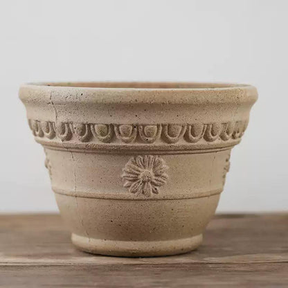 7-inch rustic white clay pot with floral design, perfect for small indoor plants. Durable terracotta pot with a classic shape and natural tones.