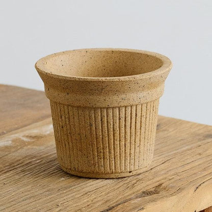 5-inch sand-colored Brûlée cup clay pot with ribbed texture, ideal for small plants or succulents. Adds a natural, rustic touch to any indoor decor.