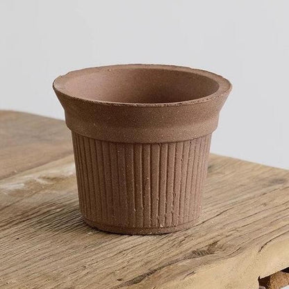 5-inch terracotta red Brûlée cup clay pot with ribbed texture, perfect for succulents or small plants. Brings a warm, earthy element to indoor decor.