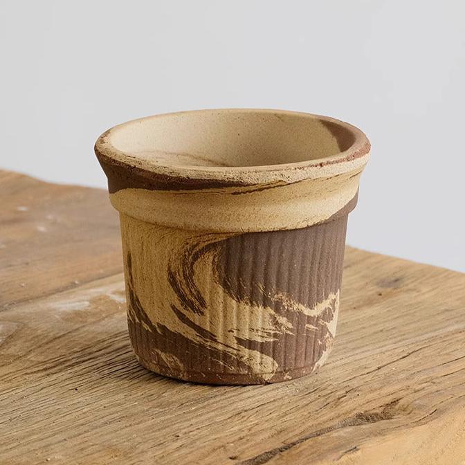 5-inch latte Brûlée cup clay pot with a marbled, ribbed design. Perfect for showcasing indoor plants, adding an artistic, earthy accent to decor.