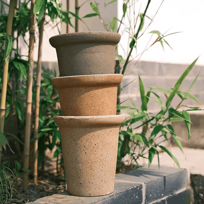 Stacked 6-inch clay flower pots in earthy tones, perfect for outdoor plants. Durable, simple design with a rustic feel.