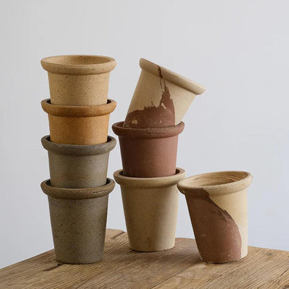 Stacked 6-inch clay flower pots in earthy tones, ideal for small plants. Sturdy design with a rustic texture, perfect for any space.