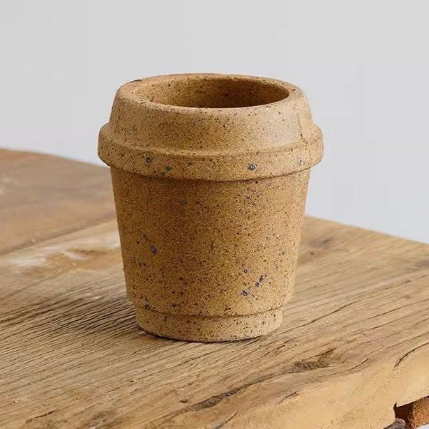 4-inch earthenware coffee cup-style pot with speckled ochre finish, perfect for succulents, on a wooden surface.