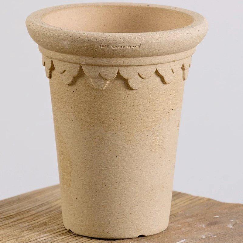 7 inch white Clover-style terracotta pot with decorative edging, perfect for enhancing indoor plants and adding charm to any space.