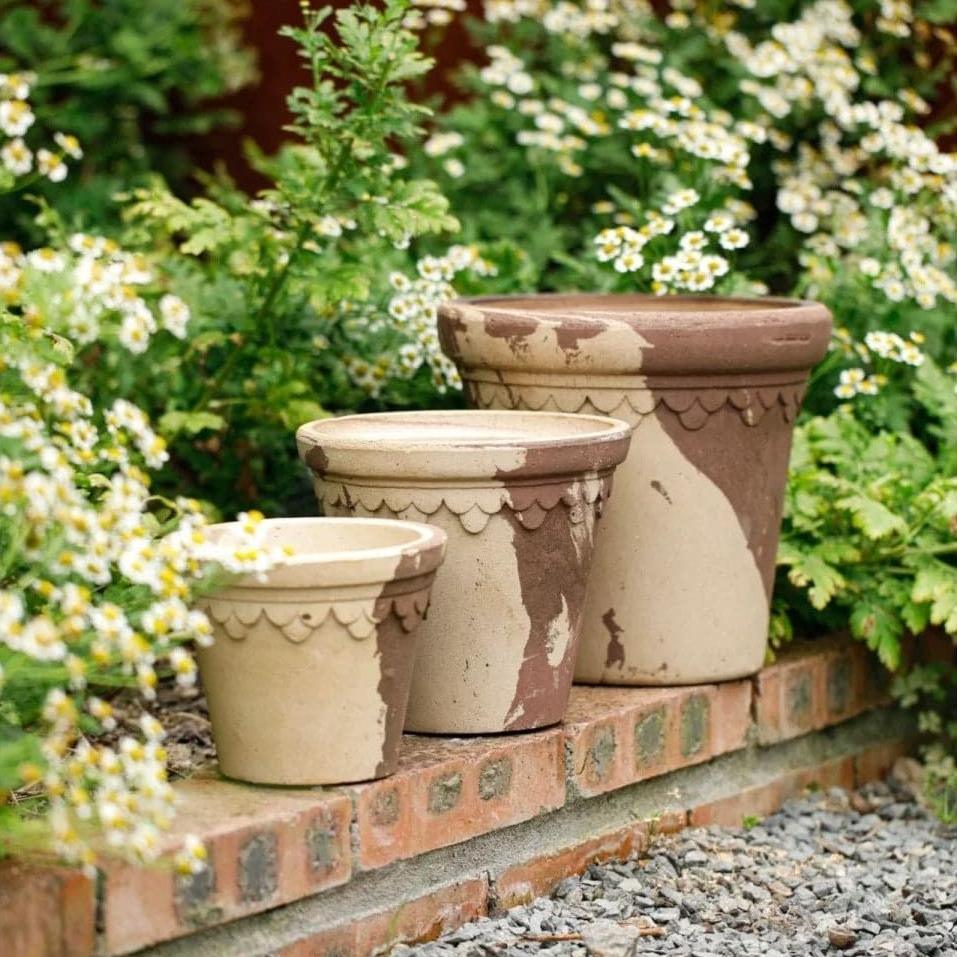 Unique brown and white terra cotta planter set in multiple sizes, including large pots. Ideal for adding style to outdoor gardens and enhancing landscape decor.